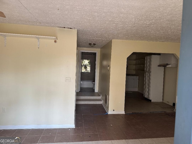 spare room with a textured ceiling