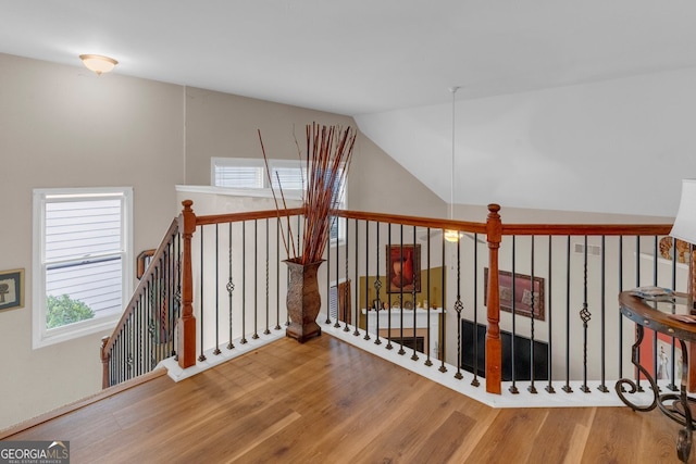 hallway featuring vaulted ceiling and hardwood / wood-style flooring