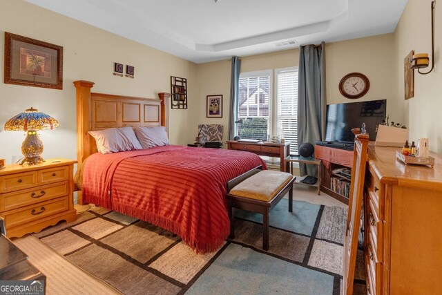 bedroom featuring a raised ceiling