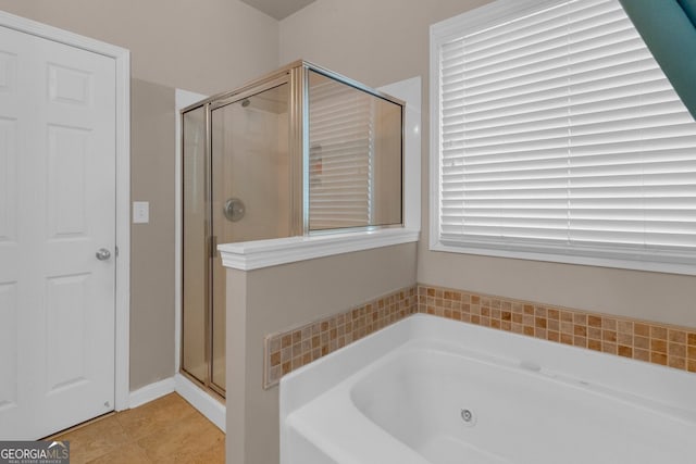 bathroom with tile patterned flooring and shower with separate bathtub