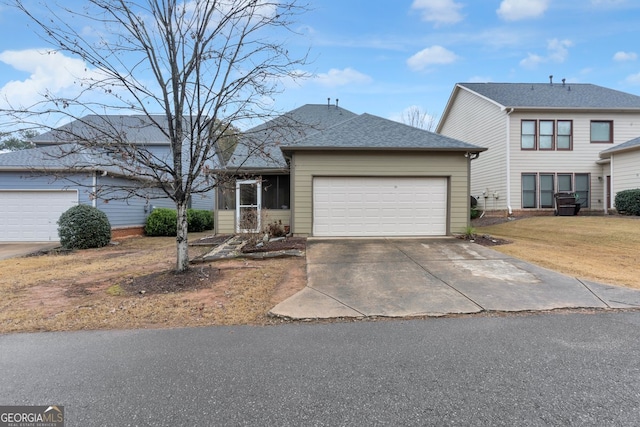 view of front of home featuring a front yard and a garage