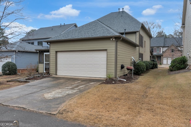 view of side of home featuring a garage and a yard