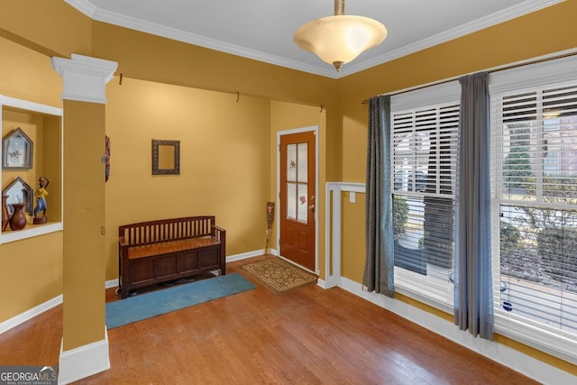 entryway featuring hardwood / wood-style floors and crown molding