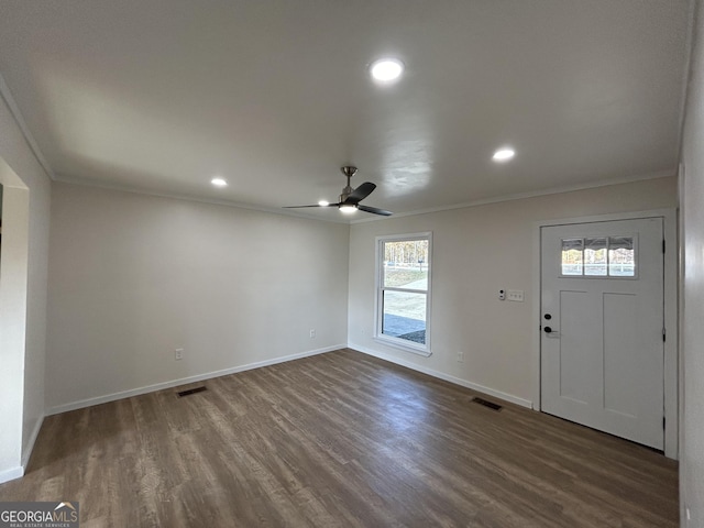 entryway with a wealth of natural light, dark hardwood / wood-style flooring, and ornamental molding