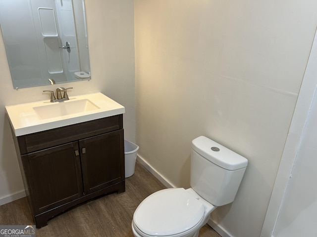 bathroom featuring hardwood / wood-style floors, vanity, and toilet