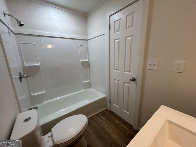 bathroom with hardwood / wood-style flooring, toilet, and shower / washtub combination