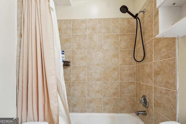 bathroom with shower / bath combo and toilet