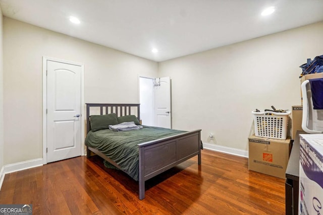 bedroom with dark wood-type flooring