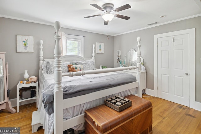 bedroom featuring ceiling fan, crown molding, and light wood-type flooring