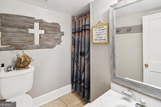 bathroom with tile patterned flooring and toilet