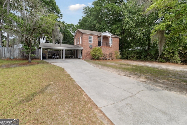 view of front of property with a front lawn and a carport