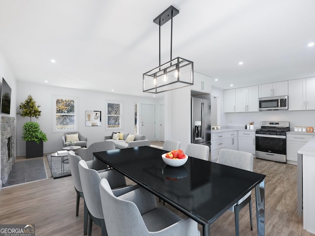 dining space with light hardwood / wood-style flooring