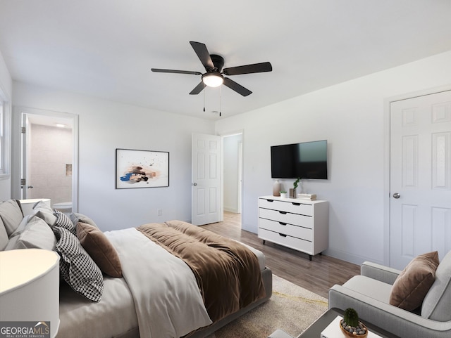 bedroom featuring ceiling fan, light hardwood / wood-style floors, and ensuite bathroom