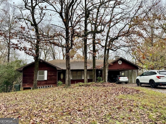 ranch-style house featuring a carport