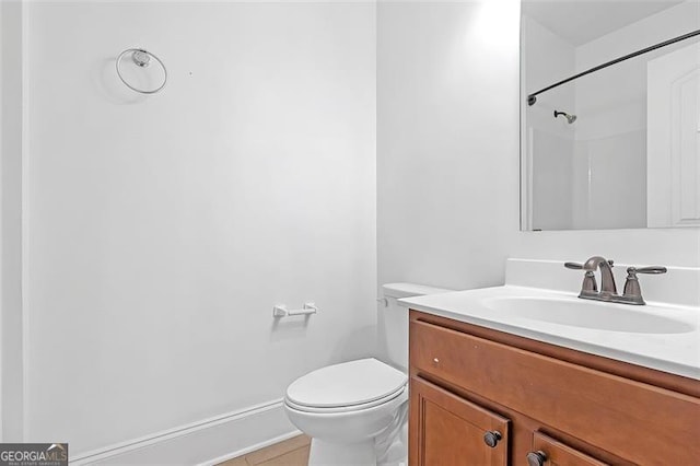 bathroom featuring tile patterned floors, a shower, vanity, and toilet