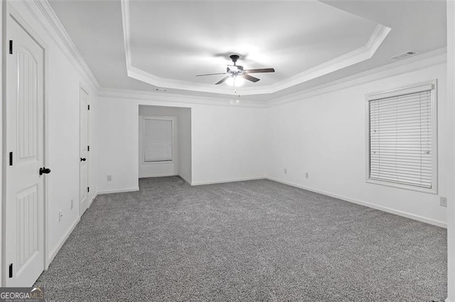 unfurnished bedroom with a tray ceiling, ceiling fan, and crown molding