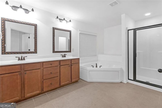 bathroom with tile patterned flooring, shower with separate bathtub, and vanity