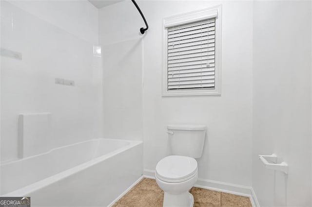 bathroom with tile patterned flooring, toilet, and shower / washtub combination