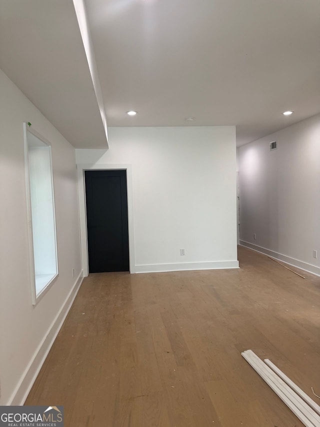interior space featuring baseboards, visible vents, light wood-style flooring, and recessed lighting