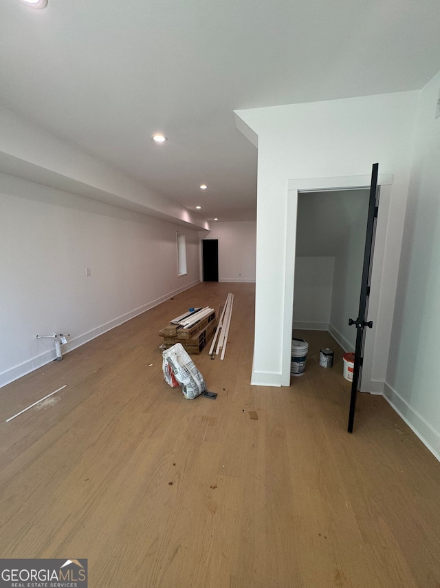 interior space featuring baseboards, wood finished floors, and recessed lighting
