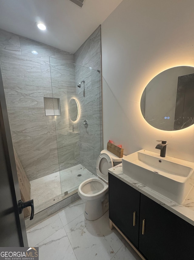 full bathroom featuring vanity, recessed lighting, toilet, marble finish floor, and tiled shower
