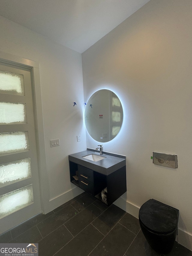 bathroom with baseboards, tile patterned flooring, and vanity
