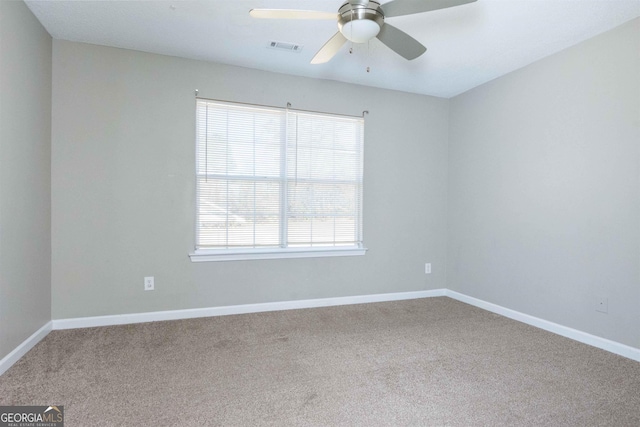 carpeted spare room with a wealth of natural light and ceiling fan