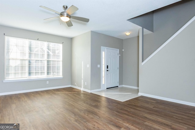 foyer entrance with wood-type flooring and ceiling fan