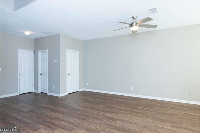 spare room with dark hardwood / wood-style floors and ceiling fan