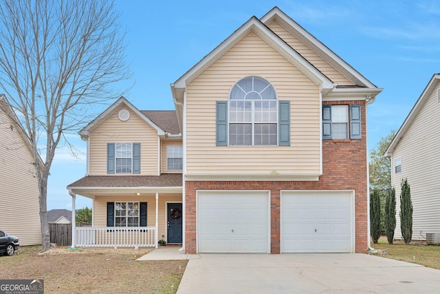 view of property with a porch and a garage