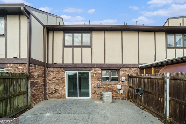 rear view of house featuring central AC and a patio