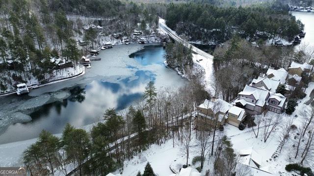 snowy aerial view featuring a water view