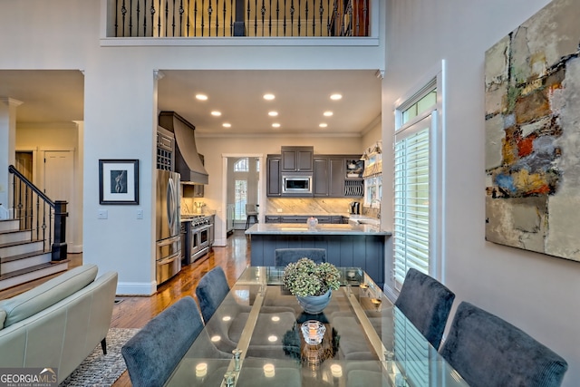 dining area with ornamental molding, dark hardwood / wood-style flooring, and a wealth of natural light