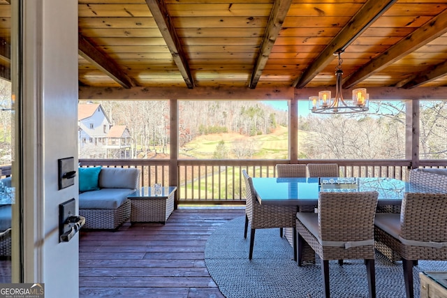 sunroom with beamed ceiling, wooden ceiling, plenty of natural light, and a notable chandelier