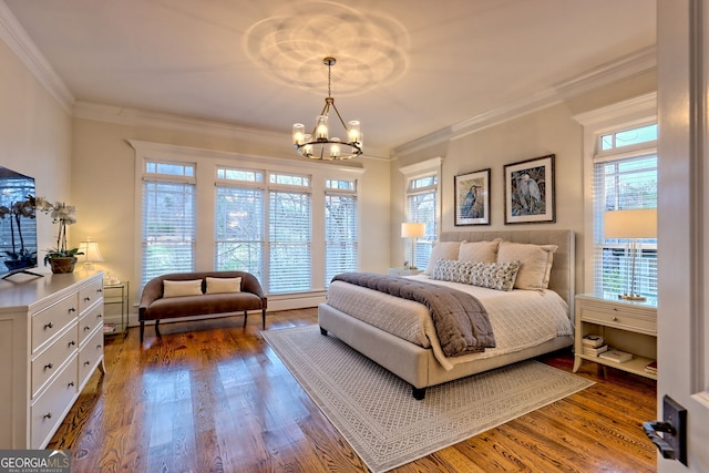 bedroom featuring ornamental molding, dark hardwood / wood-style floors, and a chandelier