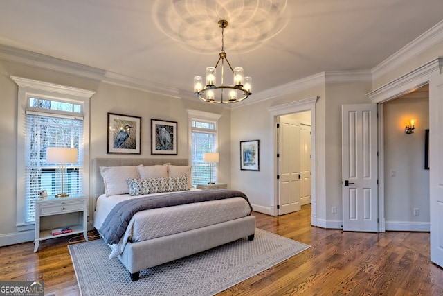 bedroom featuring ornamental molding, a chandelier, and hardwood / wood-style floors