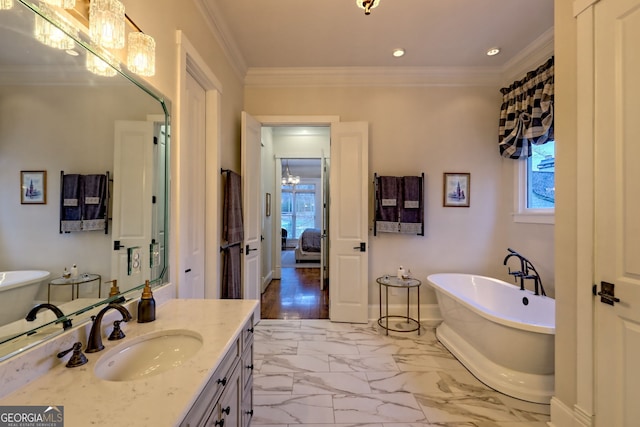 bathroom featuring vanity, a tub to relax in, plenty of natural light, and ornamental molding