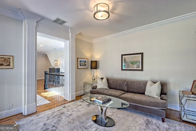 living room with hardwood / wood-style floors and ornamental molding