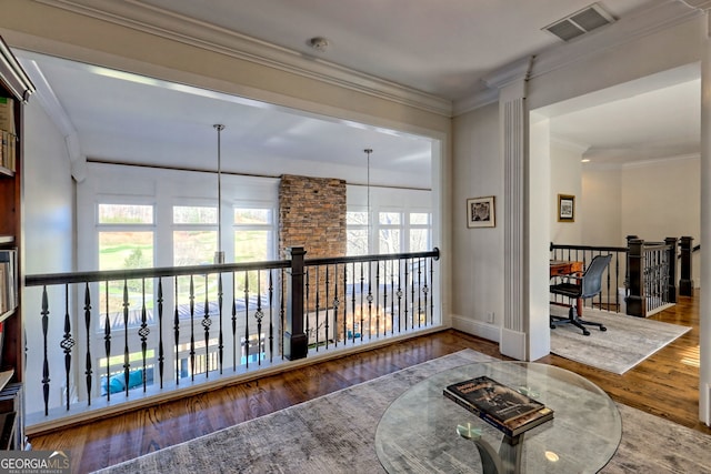 corridor featuring ornamental molding and hardwood / wood-style flooring