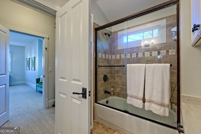 bathroom featuring bath / shower combo with glass door and tile patterned flooring