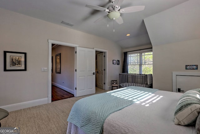 bedroom with ceiling fan, vaulted ceiling, and carpet