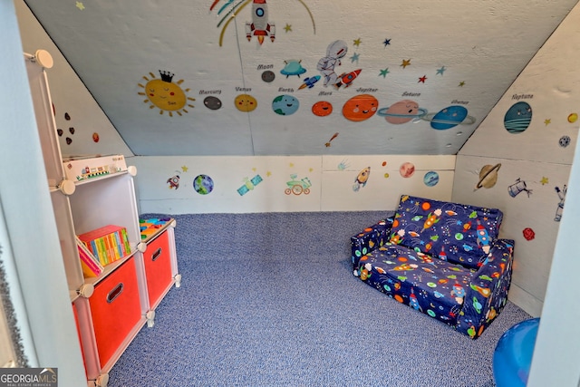 recreation room with lofted ceiling and dark carpet