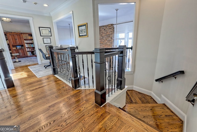 stairway featuring wood-type flooring and ornamental molding