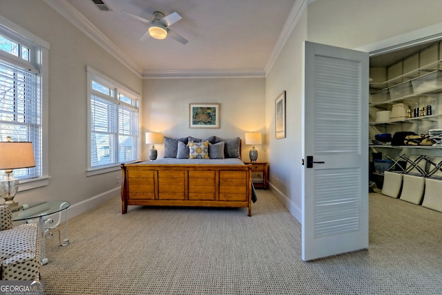 bedroom with ceiling fan, light colored carpet, and crown molding