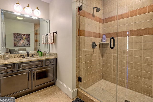 bathroom with a shower with door, tile patterned floors, and vanity