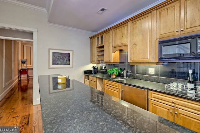 kitchen with ornamental molding, black appliances, dark stone countertops, and sink