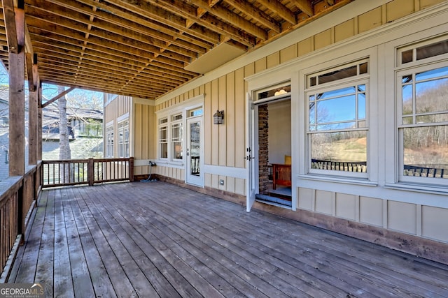 wooden terrace featuring a water view