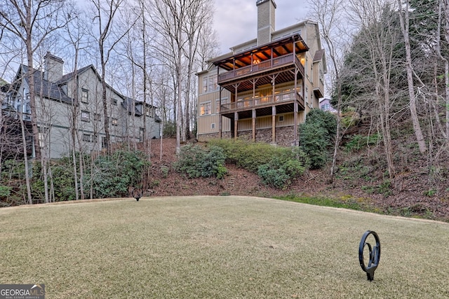 rear view of property featuring a yard