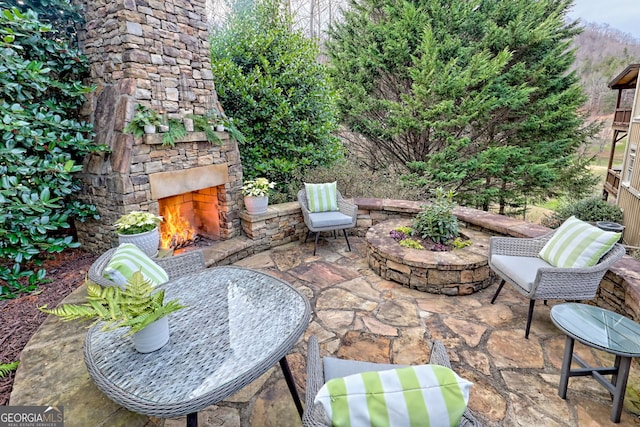 view of patio with an outdoor stone fireplace