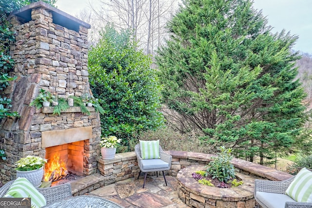 view of patio with an outdoor stone fireplace